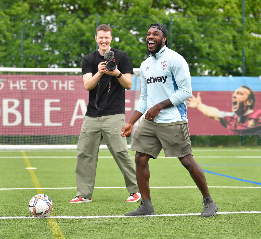 Michail Antonio and Ed Medcalf laughing together, whilst at West Ham United's training ground (Rush Green). The Picture also features Social Media Agency Corzek recording him.