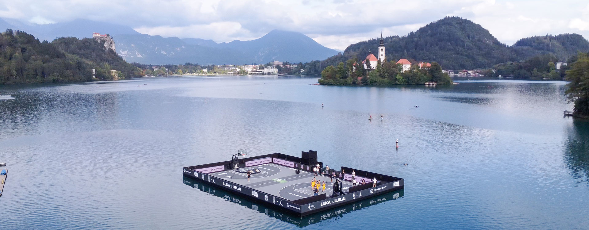 A floating basketball on Lake Bled Slovenia. In collaboration with Jordan, Grossbasket & the NBA. A photograph taken on a drone by Corzek. Contact Corzek for more photography like this.