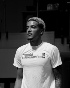 A black and white picture of Jeremy Sochan at Basketball Without Borders Camp