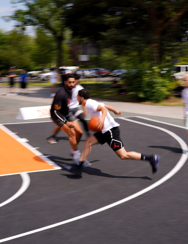 Man dribbling on an outdoor basketball court, Social media direction by Corzek